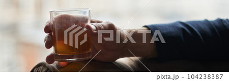 Close up shot of hand of successful business man holding glass o 104238387