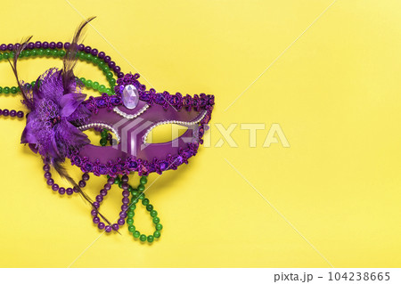 Mardi gras concept. Congratulation card with violet mask on yellow background Top view 2023 Mardi Gras Parade Schedule Mockup Copy space. Mardi gras concept. Congratulation card with violet mask on yellow background Top view 2023 Mardi Gras Parade Schedule Mockup Copy space. 104238665