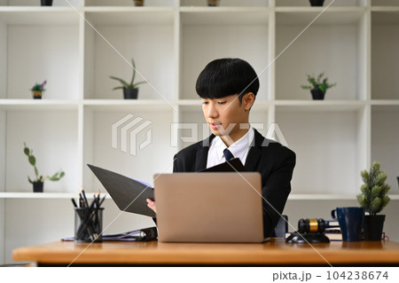 Asian businessman checking marketing research results or statistics data on laptop at his office desk Asian businessman checking marketing research results or statistics data on laptop at his office desk 104238674