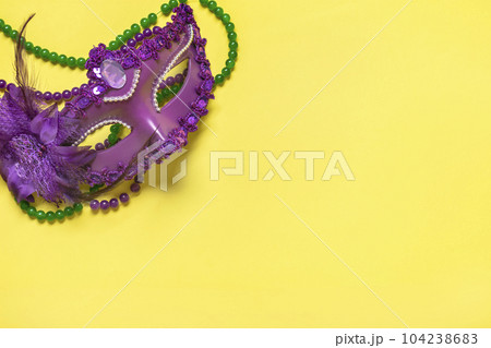 Mardi gras concept. Congratulation card with violet mask on yellow background Top view 2023 Mardi Gras Parade Schedule Mockup Copy space. Mardi gras concept. Congratulation card with violet mask on yellow background Top view 2023 Mardi Gras Parade Schedule Mockup Copy space. 104238683