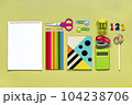 Frame from school and office supplies Paper clips, pens, calculator, sharpener, notepad, stapler isolated on green background Flat lay Top view Back to school, education concept Mock up Copy space. 104238706