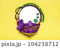Mardi gras lettering. Congratulation card with violet mask on yellow background Top view 2023 Mardi Gras Parade Schedule Mockup Copy space. 104238712
