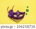 Mardi gras lettering. Congratulation card with violet mask on yellow background Top view 2023 Mardi Gras Parade Schedule Mockup Copy space. 104238716