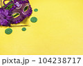 Mardi gras lettering. Congratulation card with violet mask on yellow background Top view 2023 Mardi Gras Parade Schedule Mockup Copy space. 104238717