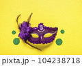 Mardi gras lettering. Congratulation card with violet mask on yellow background Top view 2023 Mardi Gras Parade Schedule Mockup Copy space. 104238718