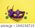 Mardi gras lettering. Congratulation card with violet mask on yellow background Top view 2023 Mardi Gras Parade Schedule Mockup Copy space. 104238719