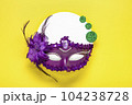 Mardi gras lettering. Congratulation card with violet mask on yellow background Top view 2023 Mardi Gras Parade Schedule Mockup Copy space. 104238728
