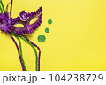 Mardi gras lettering. Congratulation card with violet mask on yellow background Top view 2023 Mardi Gras Parade Schedule Mockup Copy space. 104238729