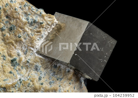 Macro Pyrite mineral stone on black background Macro Pyrite mineral stone on black background 104239952