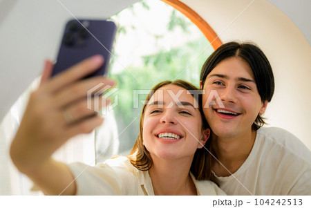 Romantic young people spending vacation time together at home 104242513