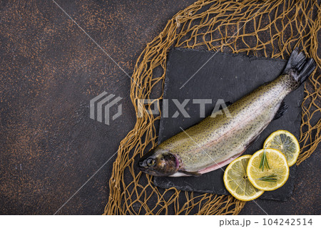 Raw uncooked trout with lemon 104242514