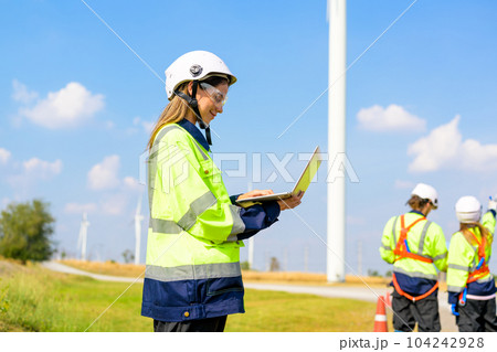 Renewable energy engineer working on wind turbine 104242928