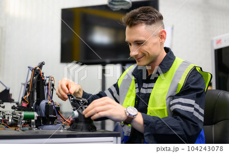 Professional technician checking and repairing part of automatic machine Professional technician checking and repairing part of automatic machine 104243078