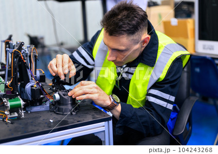 Trainee engineer learning and working in production line of industrial factory 104243268
