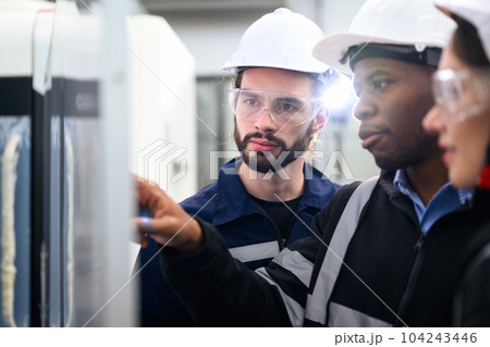 Engineer mechanician operating and controlling CNC machine Engineer mechanician operating and controlling CNC machine 104243446