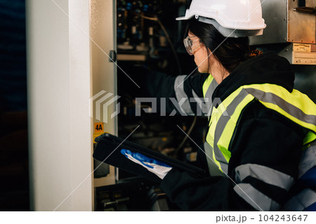 Female technician engineer using controller checking robotic machine Female technician engineer using controller checking robotic machine 104243647
