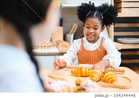 Children making bread in kitchen, Kids learning kitchen skill  104244446