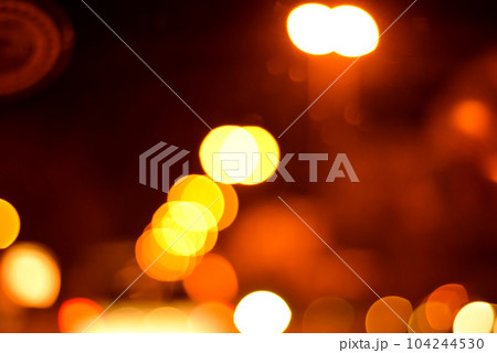 Blurred defocused lights at night. Abstract blur vehicle coming at night in the city. 104244530