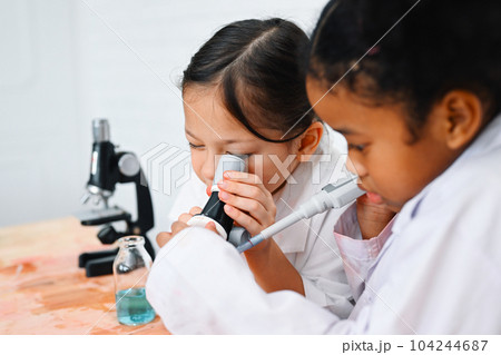 Child in classroom at school, Kid dressed science lab coat, Science concept 104244687