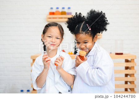 Child in classroom at school, Kid dressed science lab coat, Science concept Child in classroom at school, Kid dressed science lab coat, Science concept 104244780