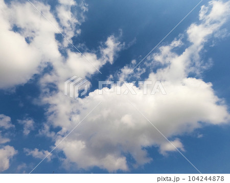 Scattered cloud clusters in a blue sky, blue sky background with white clouds. Scattered cloud clusters in a blue sky, blue sky background with white clouds. 104244878
