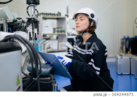 Smiling portrait of female technician checking and repairing automatic machine 104244975