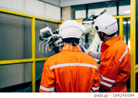 Robotics engineers team discussing and solving problems Robotics engineers team discussing and solving problems 104245094