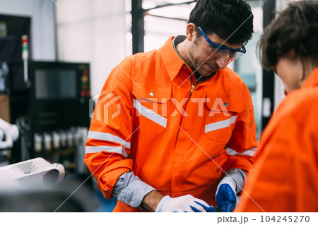 Professional technicians team checking parts of automatic machine 104245270