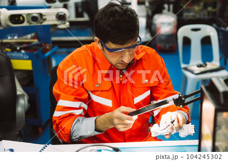 Professional technician checking and repairing parts of machine Professional technician checking and repairing parts of machine 104245302