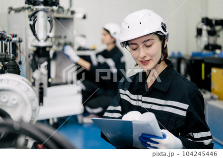 Smiling portrait of female technician checking and repairing machine 104245446