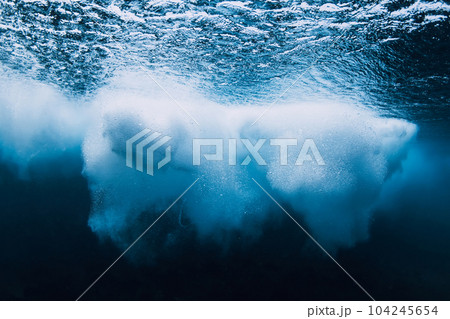 Ocean wave with foam underwater in clear water. Ocean wave with foam underwater in clear water. 104245654