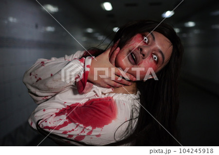 Scary woman in white dress with bloodstain after murder, Halloween concept Scary woman in white dress with bloodstain after murder, Halloween concept 104245918