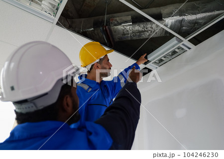 Engineers technicians with safety helmet working installing and checking system 104246230