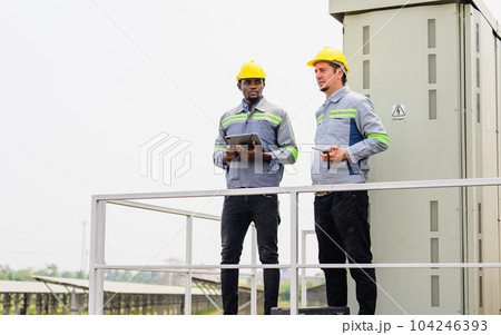 Maintenance engineer checking solar panels on solar cell farm Maintenance engineer checking solar panels on solar cell farm 104246393
