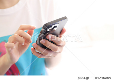 スマートフォンを操作する手元 104246809