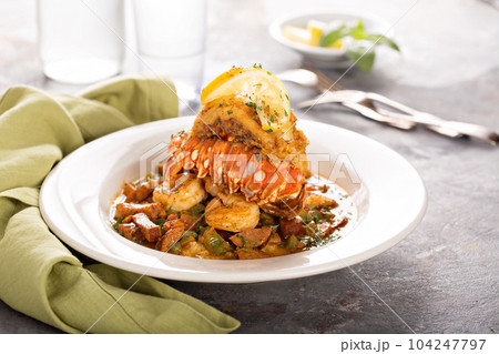 Grits with a lobster tail, shrimp and sausage 104247797