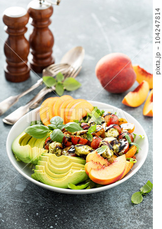 Avocado peach caprese salad with basil pesto Avocado peach caprese salad with basil pesto 104247814
