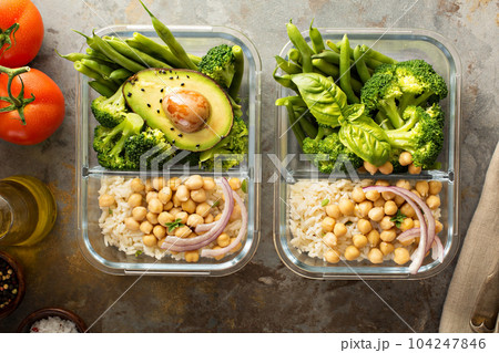 Vegan meal prep containers with cooked rice and chickpeas 104247846