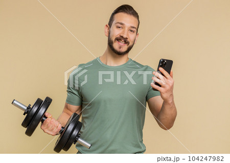 Athlete man use smartphone typing new post on web sms message browsing addiction of social networks 104247982