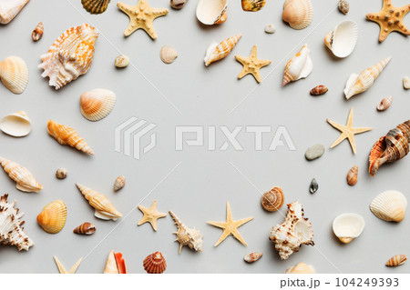 Summer time concept Flat lay composition with beautiful starfish and sea shells on colored table, top view with copy space for text 104249393