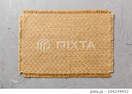 Top view of brown tablecloth for food on cement background. Empty space for your design Top view of brown tablecloth for food on cement background. Empty space for your design 104249452
