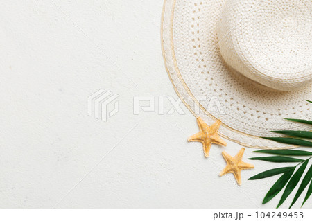 Summer holidays. Summer concept with straw hat and tropical leaf. Flat lay, top view, copy space 104249453