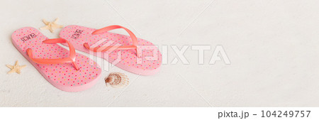 Beach accessories. Flip flops and starfish on colored background. Top view Mock up with copy space Beach accessories. Flip flops and starfish on colored background. Top view Mock up with copy space 104249757