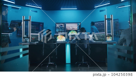 Team watch space rocket launch on big digital screens in mission control center 104250398