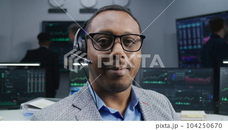 African American trader smiles and looks at camera 104250670
