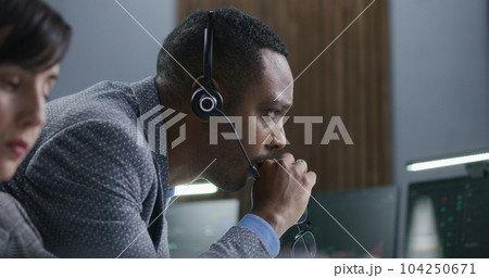 Multiracial financial analysts work on computer with real-time stocks 104250671