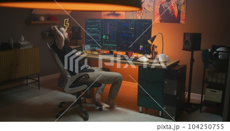 Man works remotely in cryptocurrency trading at home office Man works remotely in cryptocurrency trading at home office 104250755