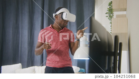 Man talks and gesticulates using VR headset Man talks and gesticulates using VR headset 104251068