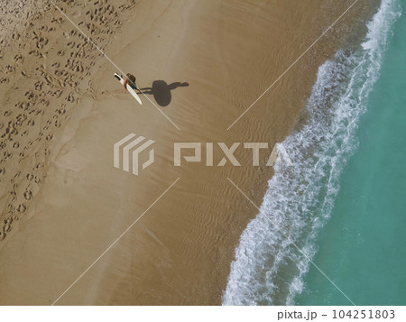 Aerial view of surfer at the beach Aerial view of surfer at the beach 104251803
