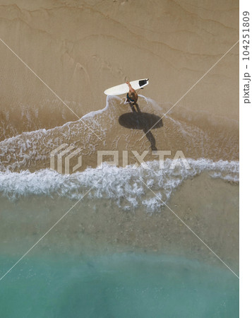 Aerial view of surfer at the beach 104251809